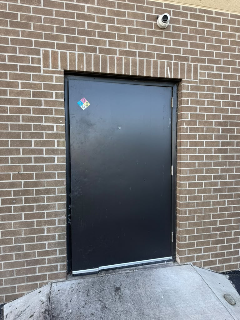 Damaged commercial hollow metal door before repair, Alexandria VA